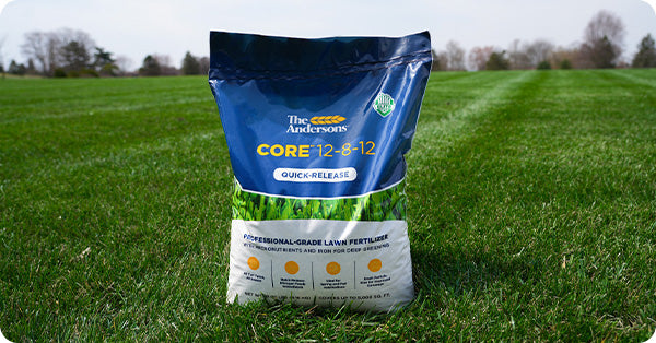 Bag of Core 12-8-12 fertilizer on green lawn